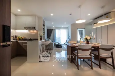Modern open-plan kitchen and dining area with elegant decor and ample natural light.