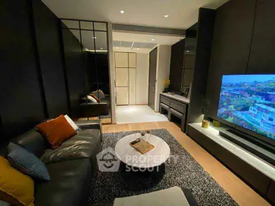 Modern living room with sleek design and large TV, perfect for relaxation.