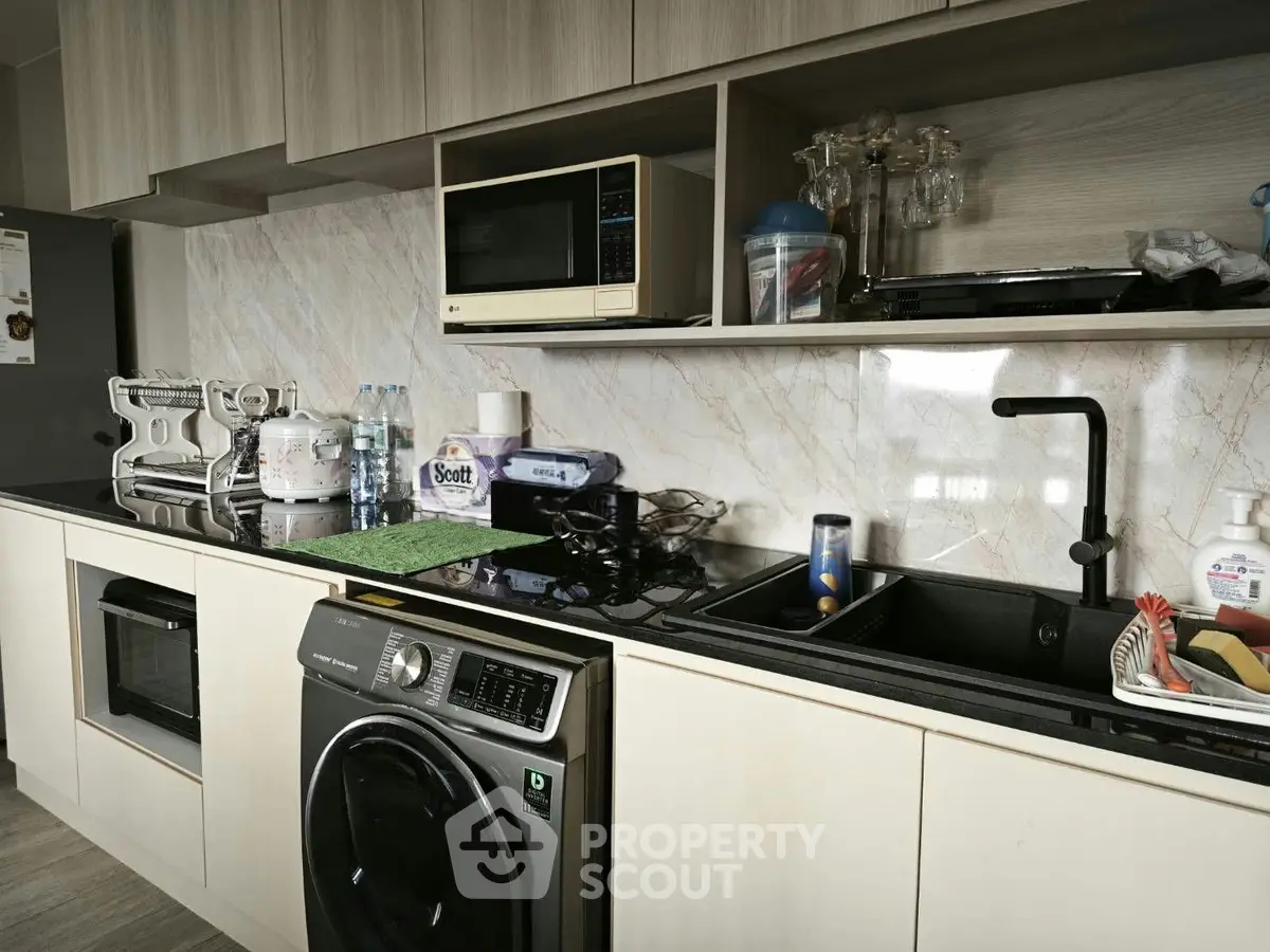 Modern kitchen with sleek appliances and ample storage space