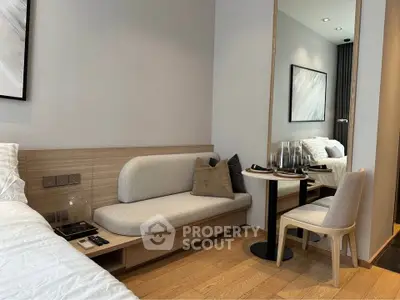 Modern bedroom with cozy seating area and elegant decor