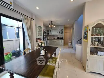 Charming open-layout kitchen and dining area with elegant decor and garden view.