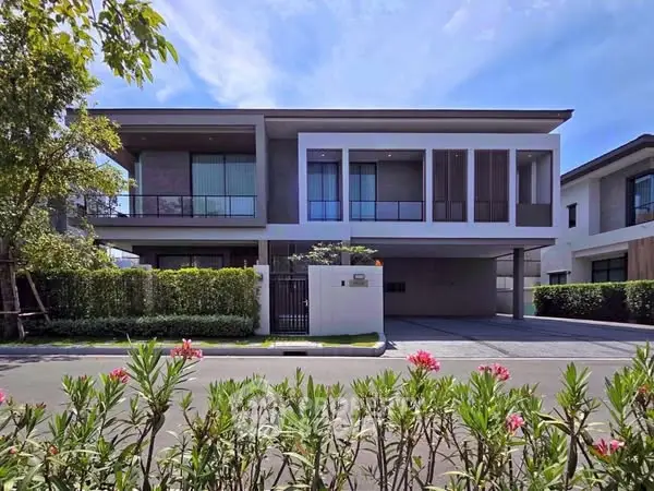Modern two-story house with lush garden and sleek design