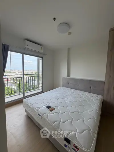 Modern bedroom with large window and city view, featuring a comfortable bed and sleek design.