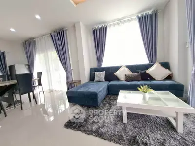 Spacious living room with modern blue sofa and elegant decor