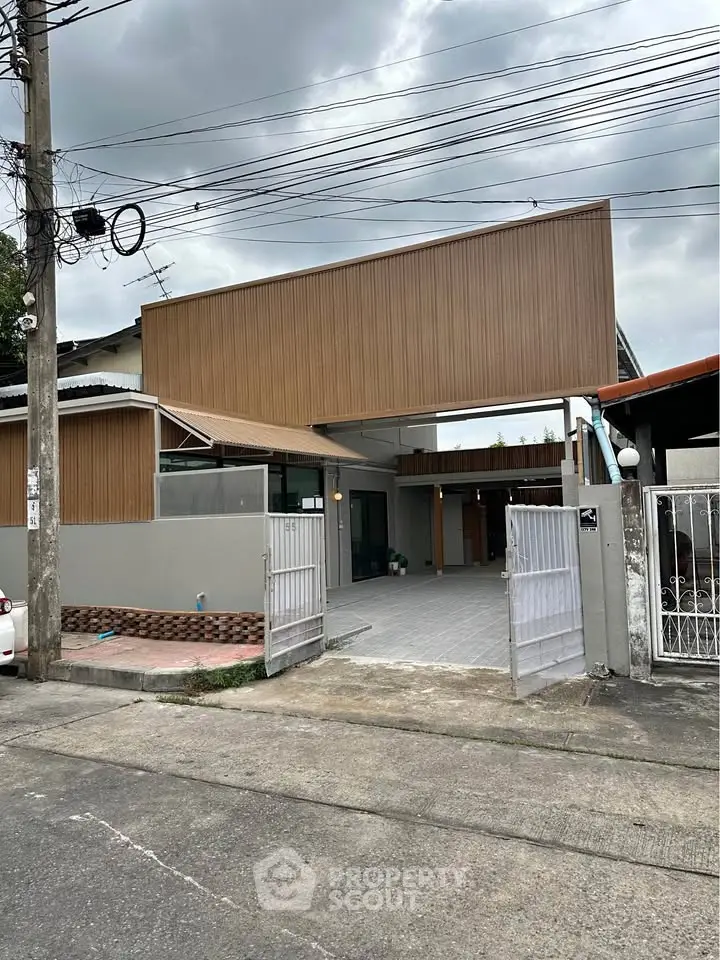 Modern residential building with unique architectural design and spacious entrance.