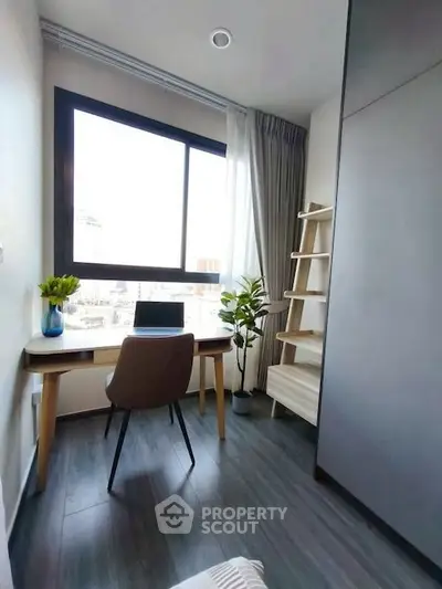 Modern study room with large window and stylish desk in a high-rise apartment.