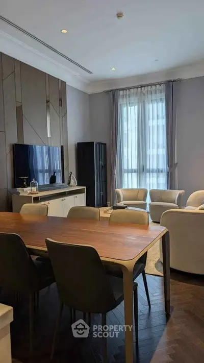 Elegant living room with modern furniture and large window, perfect for stylish urban living.