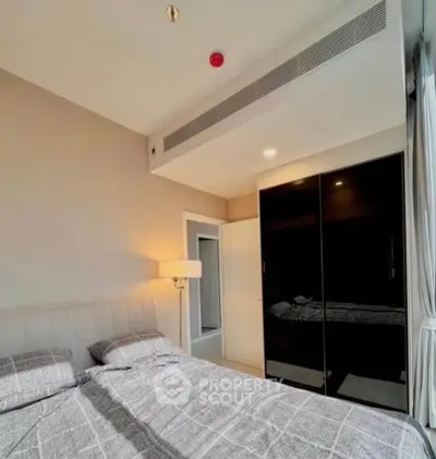 Modern bedroom with stylish decor and ample natural light