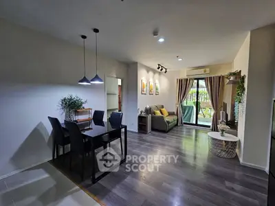 Spacious modern living room with dining area and large windows for natural light.