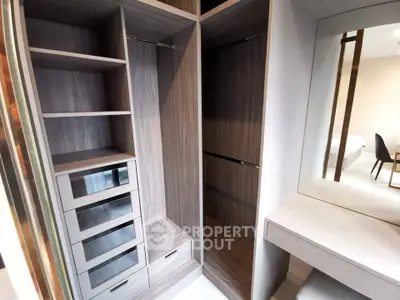 Spacious walk-in closet with modern shelving and drawers in a stylish bedroom.
