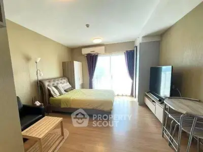 Spacious modern bedroom with balcony and natural light in a stylish apartment.