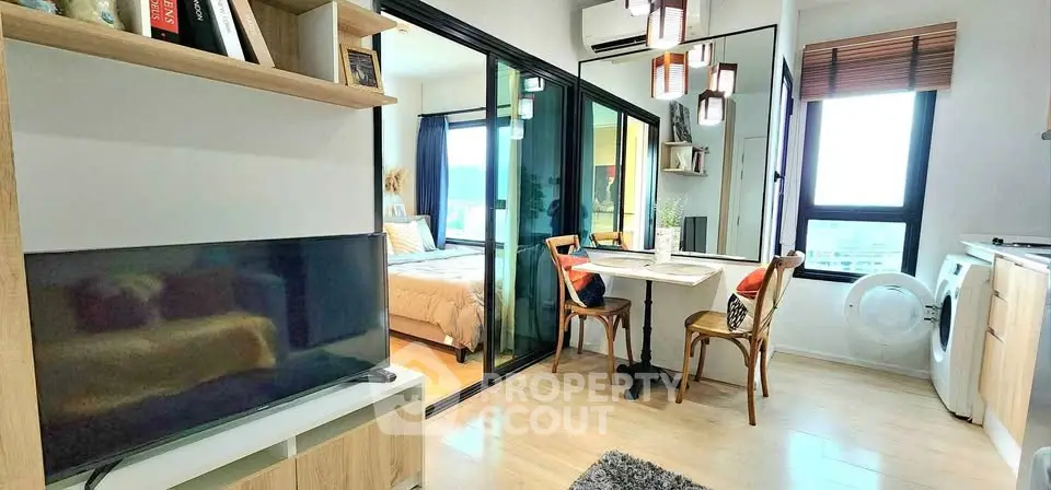 Modern apartment interior with open living and dining area, featuring a cozy bedroom and stylish decor.