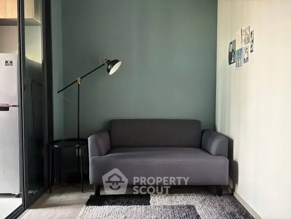 Modern living room with stylish gray sofa and floor lamp, perfect for cozy relaxation.