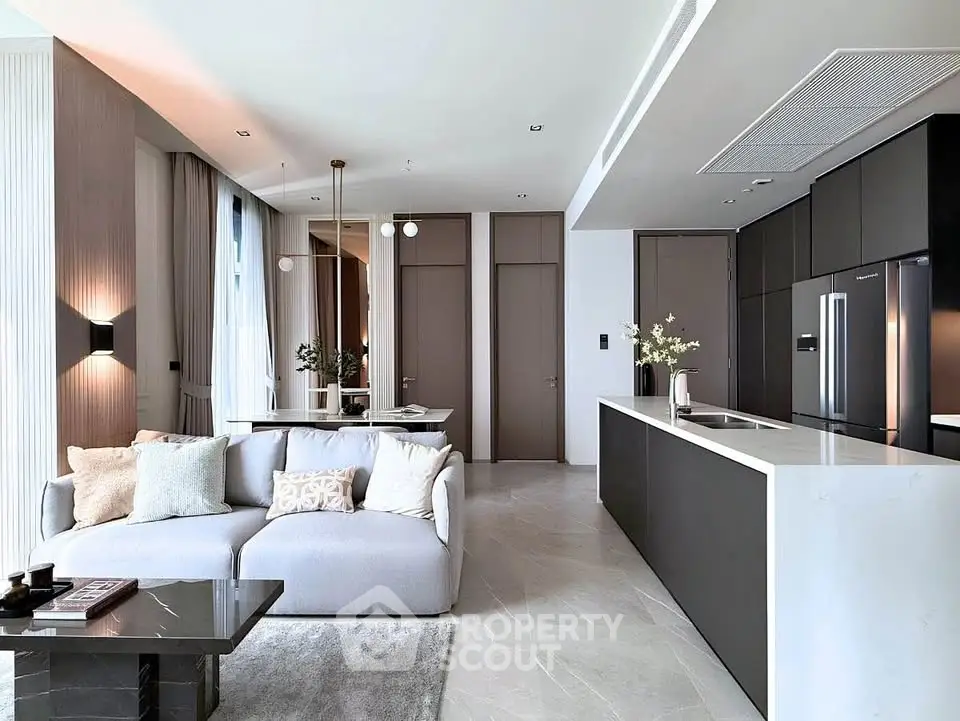 Luxurious open-plan living room and kitchen with modern design and elegant furnishings.