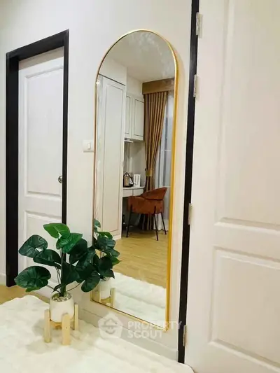 Stylish interior with modern mirror and elegant decor in a cozy living space.