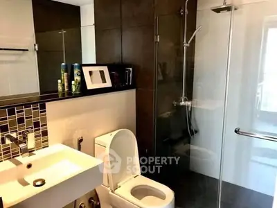 Modern bathroom with glass shower and sleek fixtures