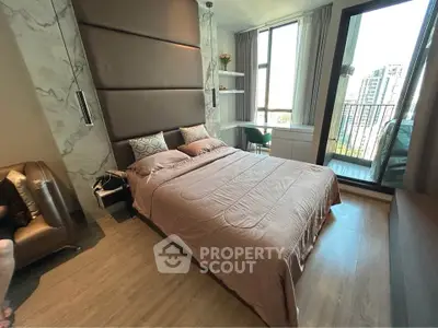 Luxurious bedroom with modern decor and balcony view in high-rise apartment