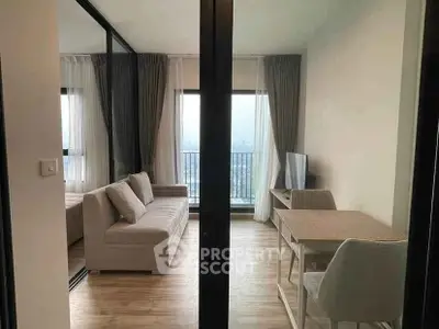 Modern living room with stylish furniture and large windows offering a stunning city view.