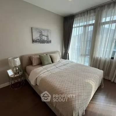 Cozy bedroom with elegant decor and large windows for natural light