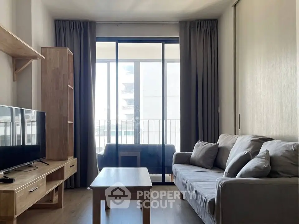 Modern living room with large windows and stylish furniture, perfect for relaxation and entertainment.