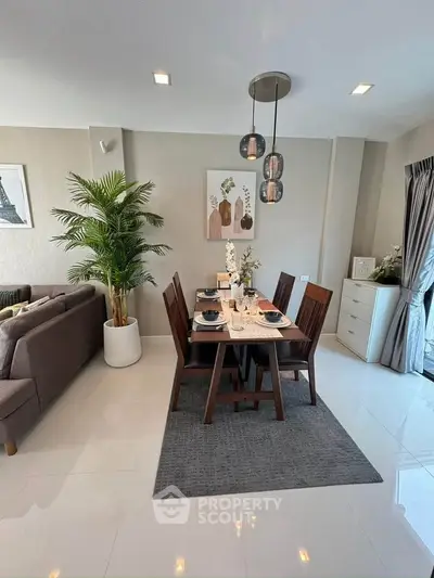 Modern dining area with elegant decor and natural light in a stylish apartment.