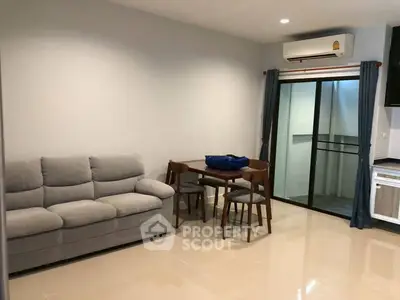 Modern living room with cozy sofa, dining table, and air conditioning in a stylish apartment.