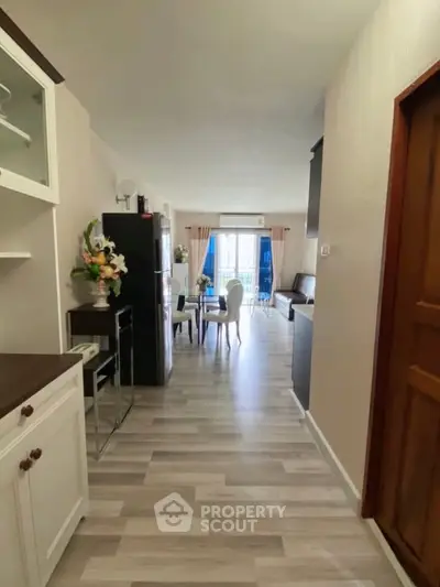 Spacious open-plan living room with modern decor and natural light