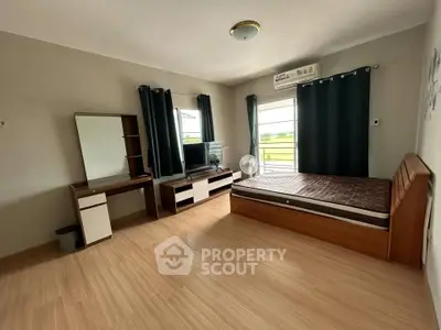 Spacious bedroom with modern furnishings and natural light