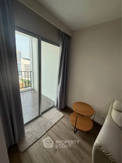 Cozy living room with balcony access in modern apartment