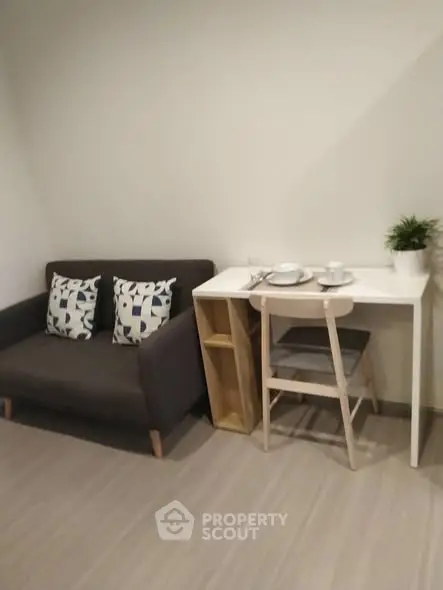 Cozy living area with modern sofa and compact dining setup.