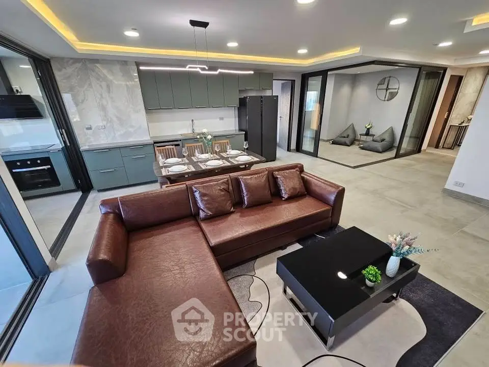 Spacious modern living room with open kitchen and stylish decor