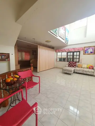 Spacious living room with bright decor and ample natural light