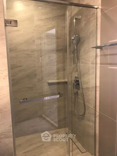Modern bathroom with glass shower enclosure and sleek fixtures