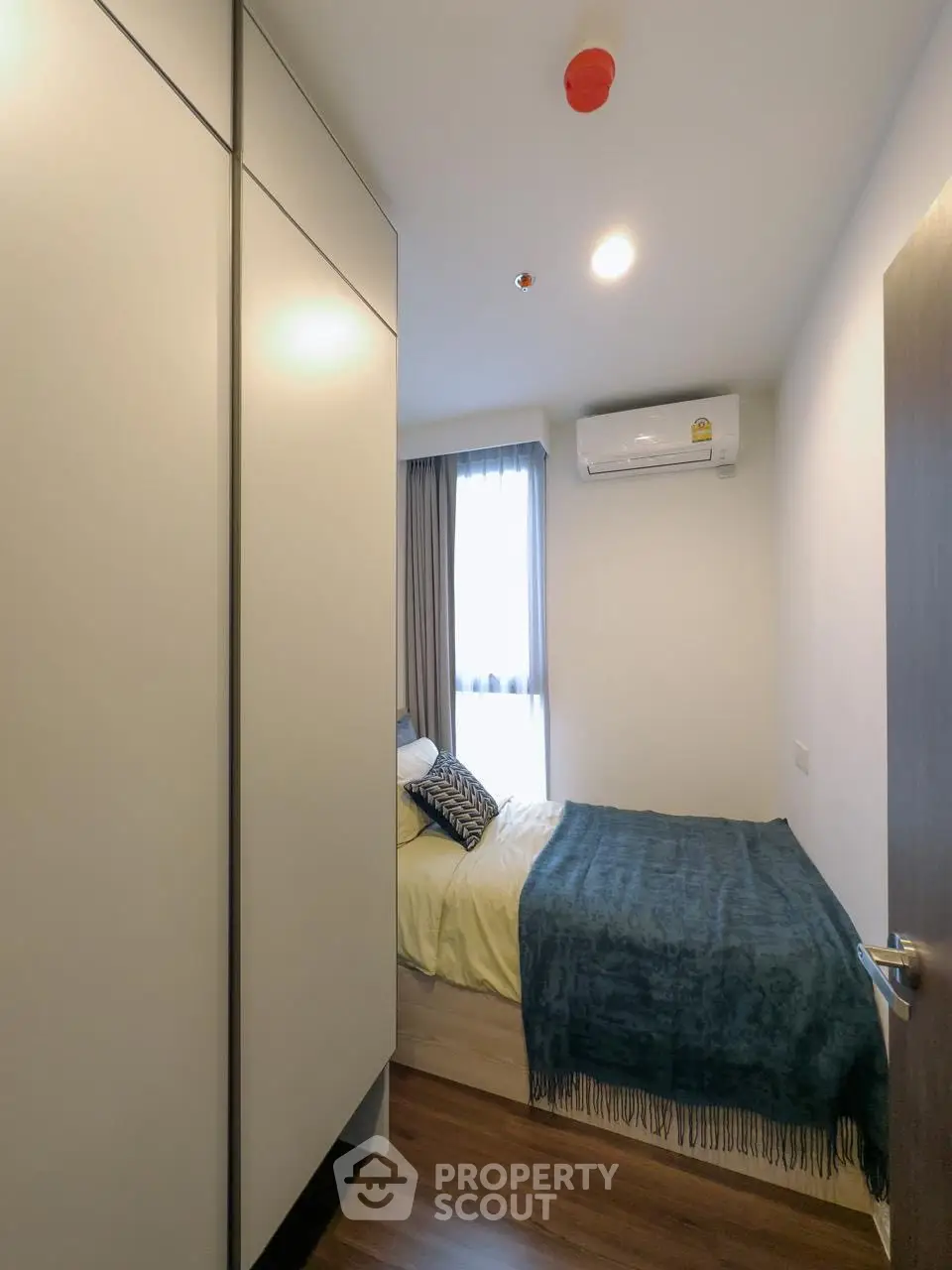Cozy bedroom with modern decor and air conditioning, perfect for restful nights.