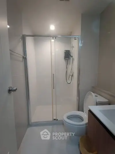 Modern bathroom with glass shower and sleek fixtures
