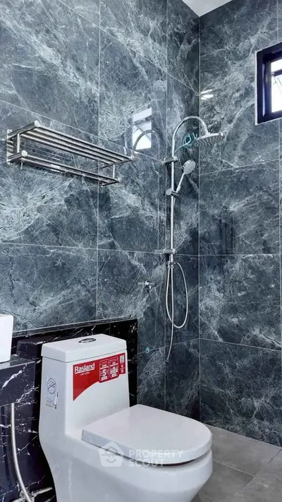 Luxurious modern bathroom with sleek marble tiles and contemporary fixtures.