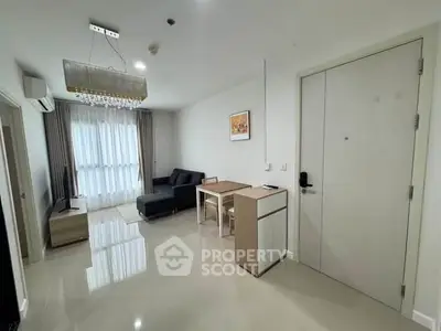 Modern living room with sleek furniture and natural light, perfect for urban living.