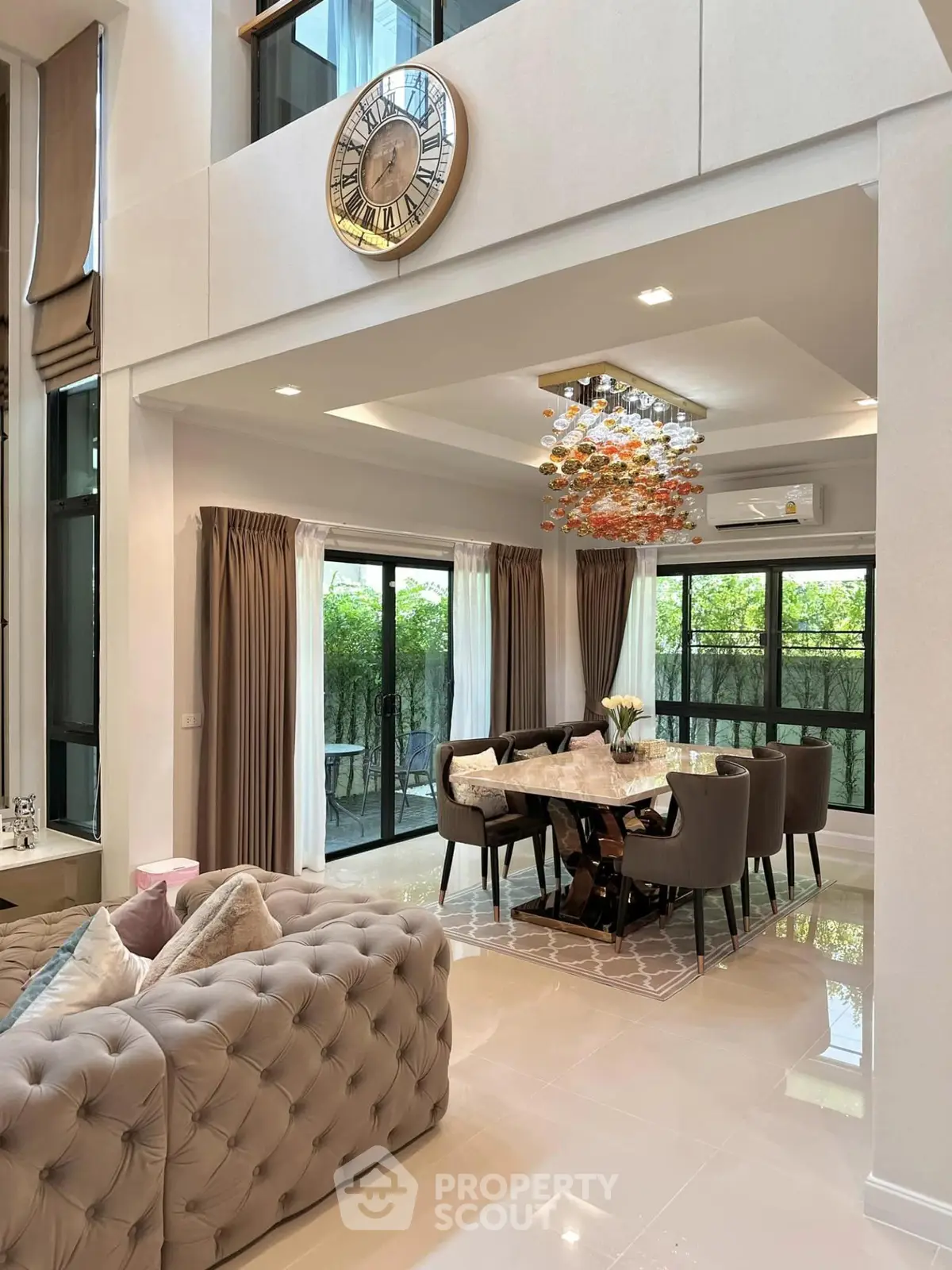Luxurious modern living room with elegant dining area and large windows for natural light.