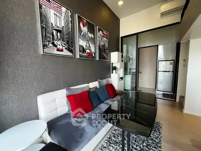 Modern living room with stylish decor and open kitchen layout in a chic apartment.