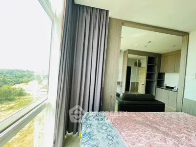 Spacious bedroom with large window offering scenic views and modern furnishings.