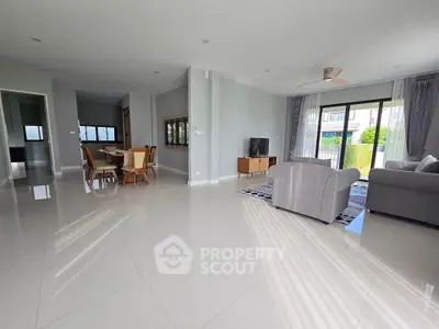 Spacious modern living room with large windows and elegant furniture