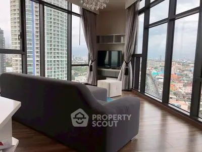 Luxurious corner unit living room with panoramic city views and elegant decor.