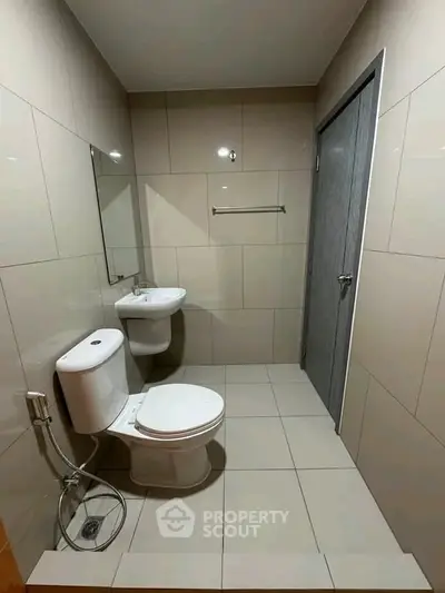 Modern bathroom with sleek fixtures and neutral tiles, perfect for a contemporary home.