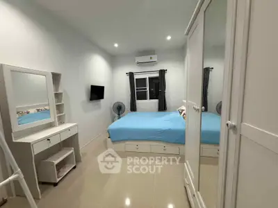 Spacious bedroom with modern furnishings and ample storage in a cozy apartment.
