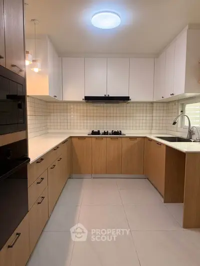 Modern kitchen with sleek cabinetry and gas stove in a stylish home