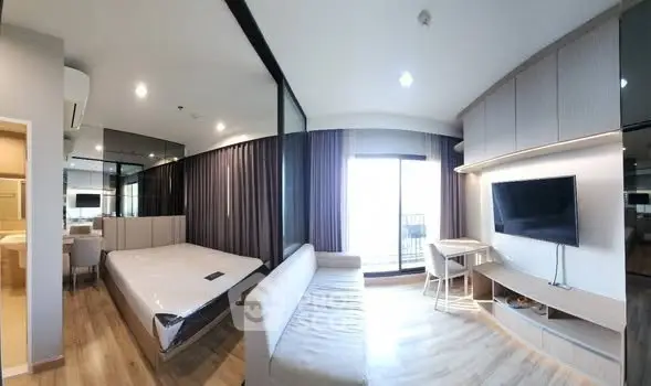 Modern studio apartment with open layout and balcony view
