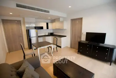 Modern open-layout living room with sleek kitchen and stylish furniture