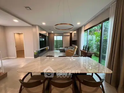 Spacious modern living room with garden view and elegant dining area