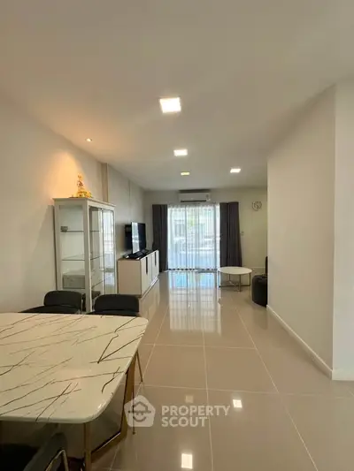 Spacious modern living room with sleek furniture and large windows for natural light.
