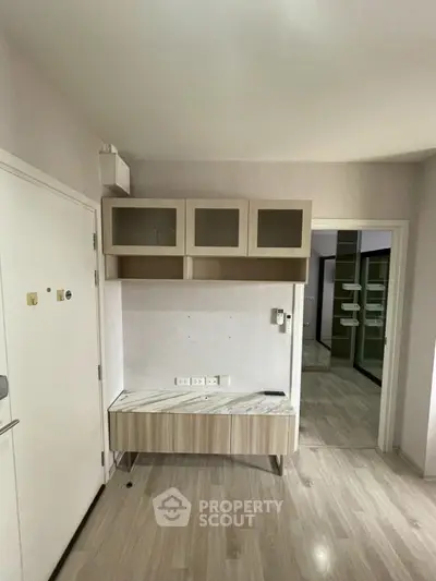 Modern interior with built-in storage and sleek flooring, ideal for urban living.